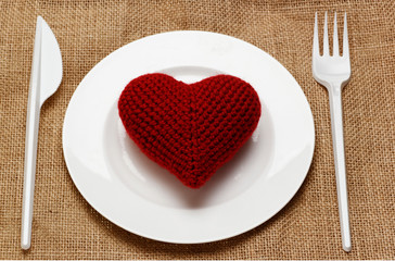 red heart in plate with knife and fork