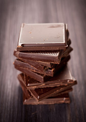 Pieces of chocolate on a wooden board