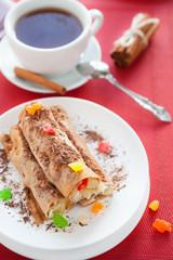 pancakes with fruit in the middle of a cup of black tea