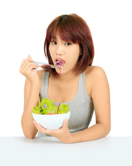 Isolated young asian girl with a bowl of salad