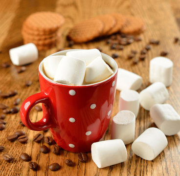 Coffee with marshmallows in a red cup