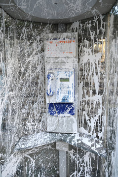 Public Telephone Vandalized with White Paint