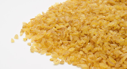 Heap of  bulgur wheat groats isolated