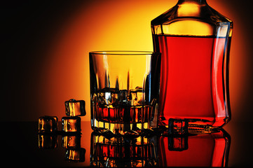 Bottle of whisky and glass with ice
