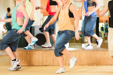 Zumba or Jazzdance - young people dancing in studio