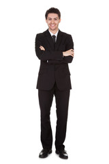 Obraz na płótnie Canvas Businessman standing with folded arms