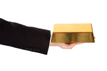 Businessman holding out a gold bar