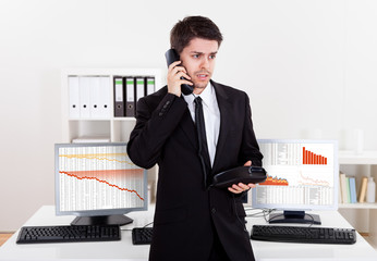 Worried stock broker on the phone