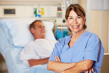 Portrait Of Nurse With Patient In Background
