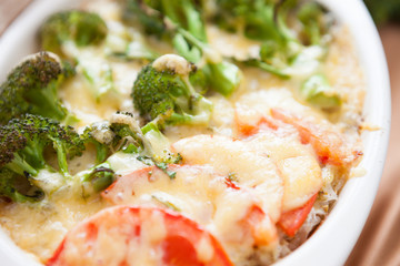 prepared broccoli with cheese and tomatoes