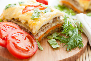  large piece of vegetable lasagna on a wooden surface