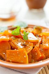 pumpkin cooked with spices on a ceramic dish