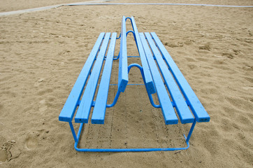 blue bench on sea beach sand