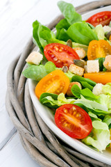 Salad with tomatos and croutons on a plate