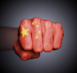Front view of punching fist on gray background