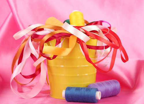Color bucket with multicolor ribbons and thread
