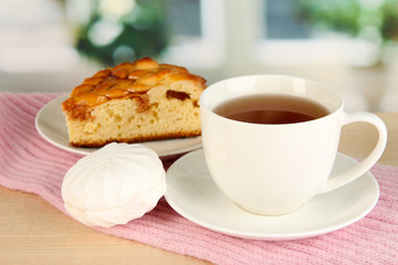 cup of tea with scarf on table in room