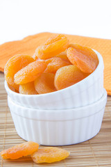 Dried apricots in a white ceramic bowl