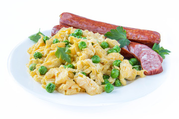Scrambled eggs with fresh green peas and sausage