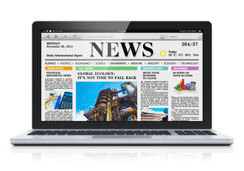 Laptop with business news site on screen