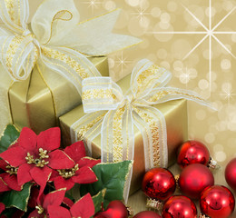 Gold wrapped presents with red flowers and baubles.