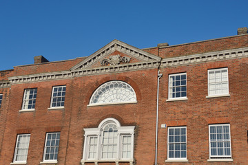 Fototapeta na wymiar Traditional red brick building with windows