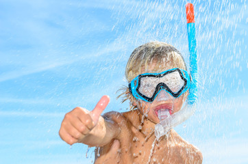 blonde boy with snorkel and diving mask thumb up