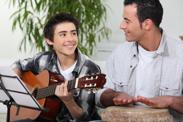 Father and son playing music