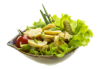 Marinated mushrooms in white saucer isolated on white
