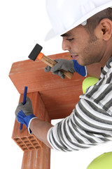 Mason chiseling brick © auremar