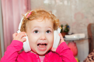 Cute little girl singing in headphones