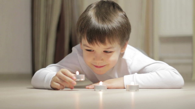 little boy blows out the candles