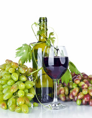 bottle, glass of wine and ripe grapes isolated on white