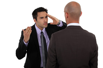 Two businessmen not seeing eye to eye