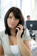 Secretary stood in open-plan office