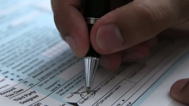 Signing a 1040 income tax return form