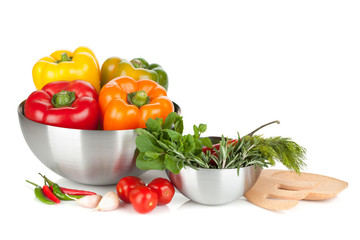 Fresh bell peppers and herbs in bowls