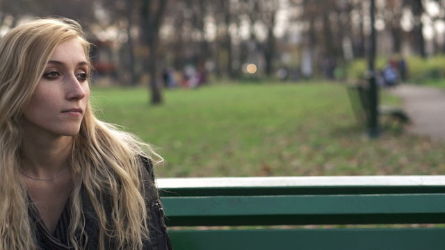 Relationship difficulties, couple sitting in park