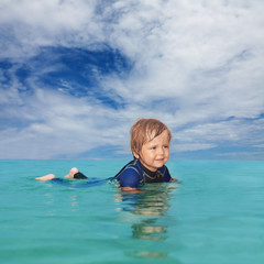 Little boy laying in the water