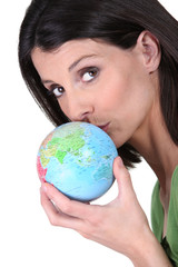 Woman kissing globe