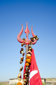 hindu god Shiva sacred trident and red flags