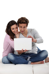 Young couple on sofa with laptop