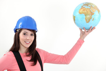 Construction worker holding a globe.