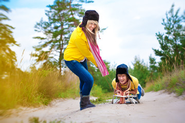 crazy boy and girl are sledding at summer