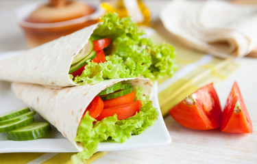 lettuce and tomatoes wrapped in pita bread
