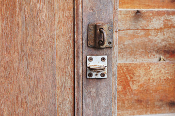 old wood door and old rusty hasp