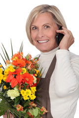mature florist holding bouquet