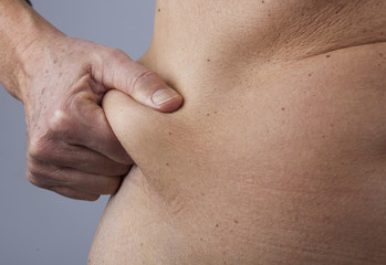 Naklejka premium female person checking her belly fat