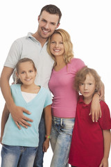 portrait of young happy caucasian family standing together with