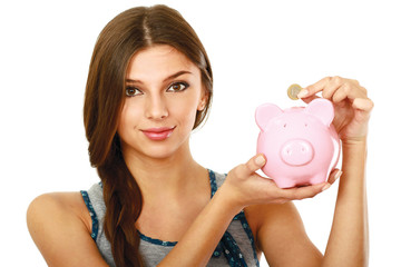 Young beautiful woman standing with piggy bank